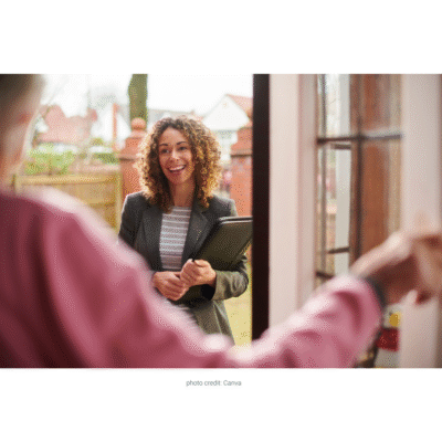 Female fieldworker arriving at a client's home, greeted at the door by the client, illustrating a safe and professional home visit.